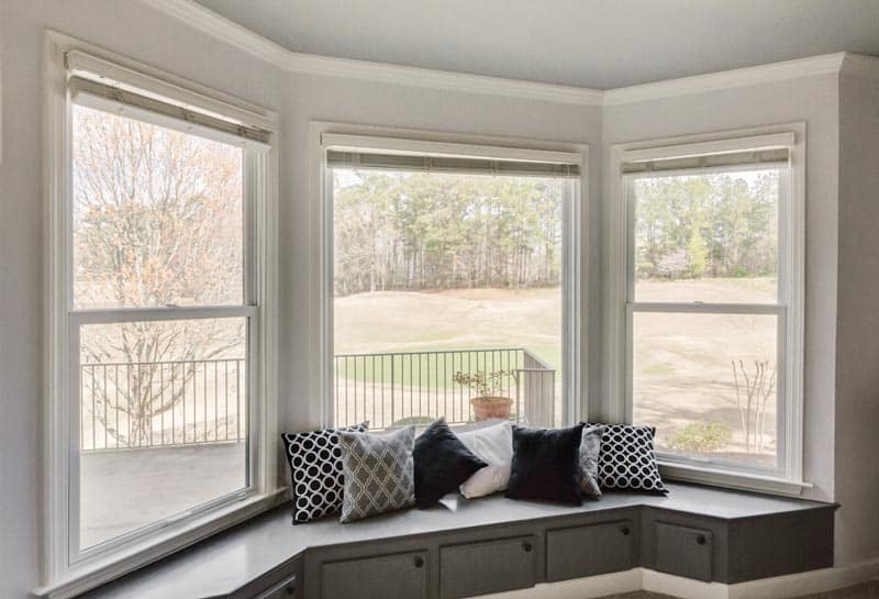 Double-hung windows over a bumped-out bay window seat
