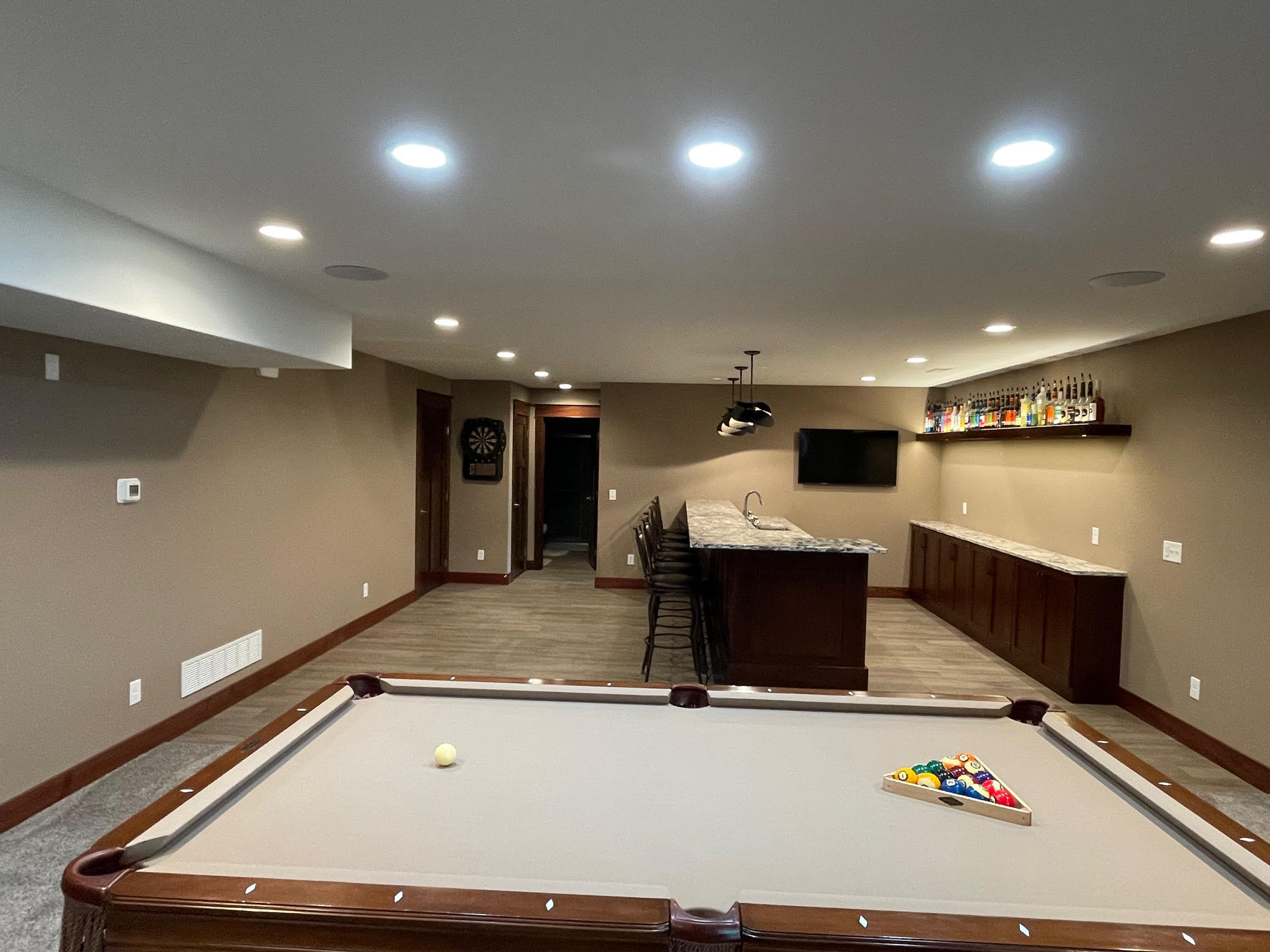 Finished basement with pool table and wet bar