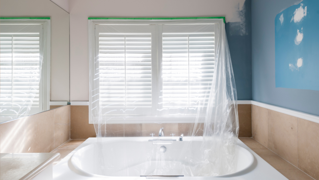 Bathroom window tapped off with plastic to contain remodeling mess 