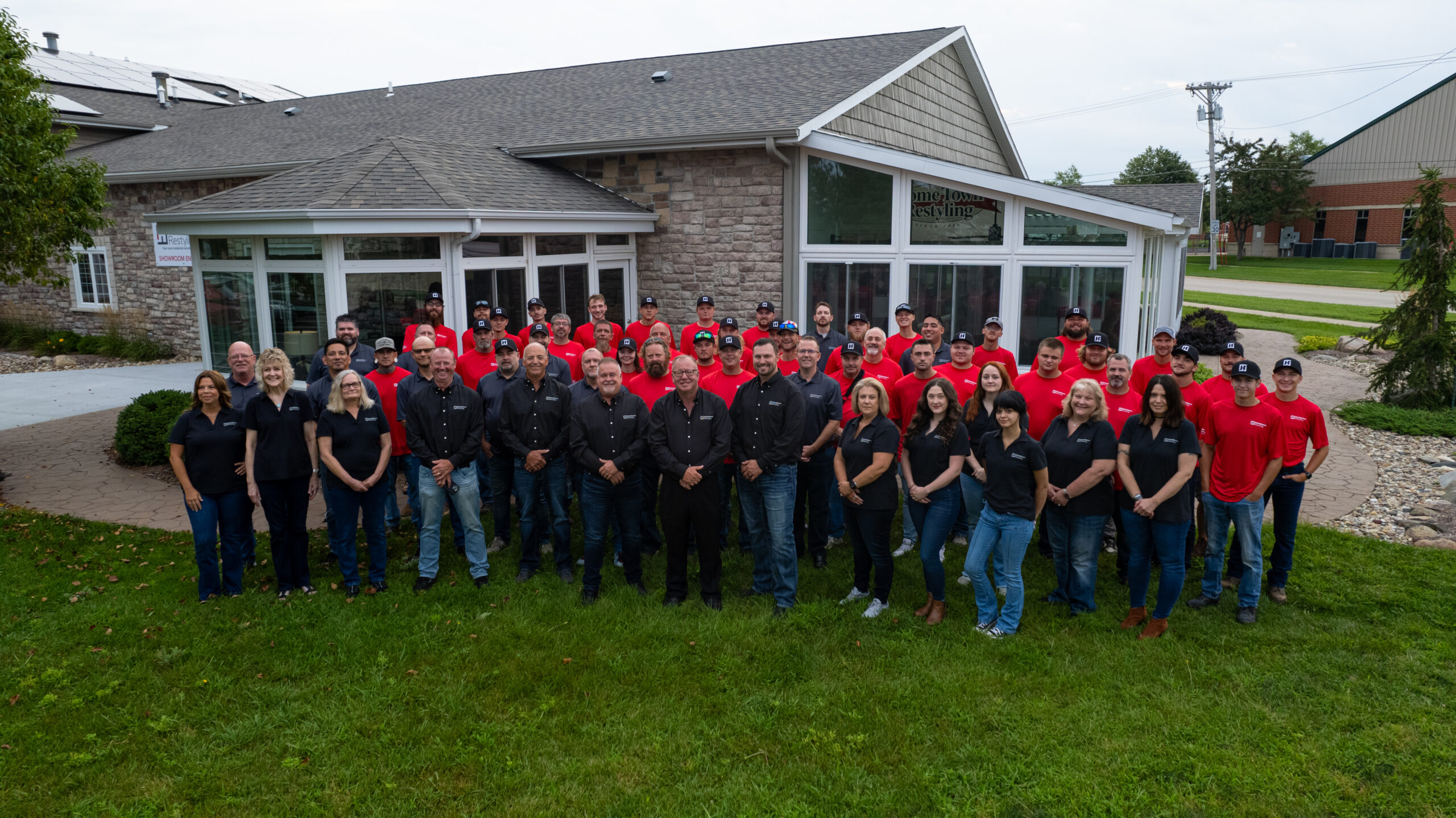 hometown restyling crew outside their local eastern Iowa showroom